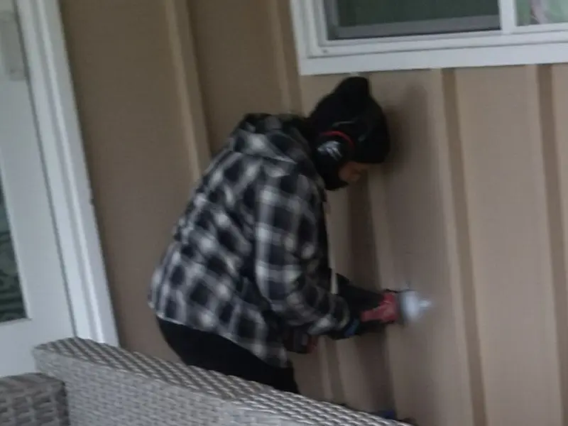 Professional electrician installing an exterior outlet in Lawrence