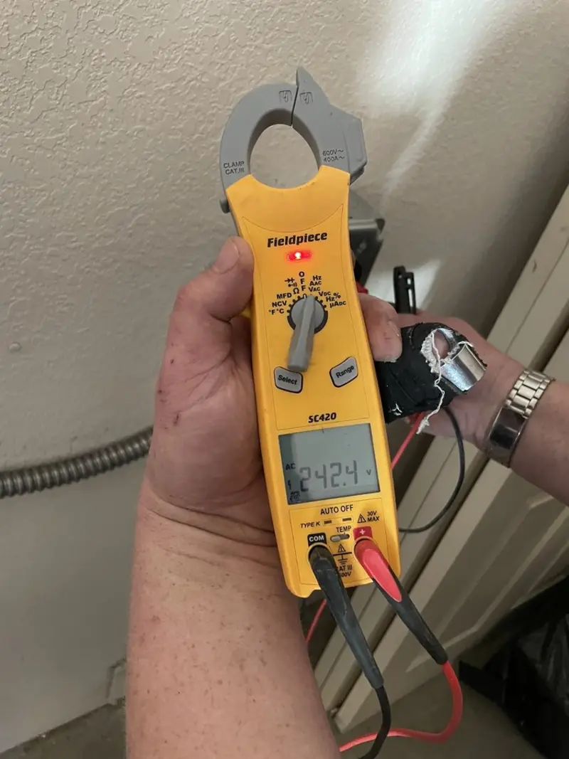 Voltage testing with clamp meter during Outlet Installation in Lawrence